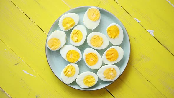 Boiled Chicken Eggs on a Blue Ceramic Plate. The Concept of Easter Holidays