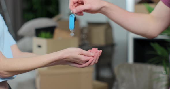 Man Handing Keys of New House to Woman Customer