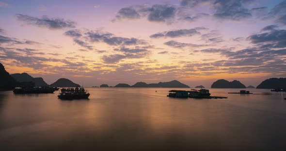 Time lapse: Vietnam Cat Ba bay at sunset to night with floating fishing boats on sea