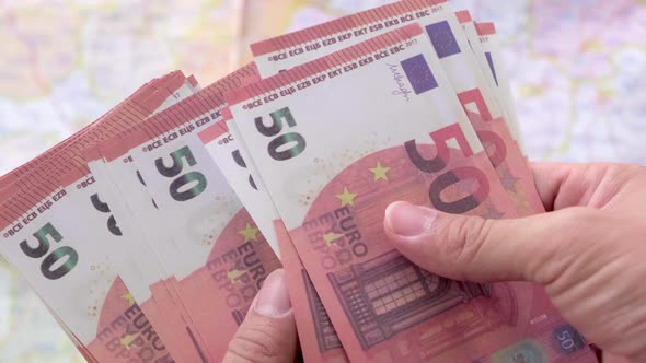 Man holding euro paper currency and counting 50 euro banknotes