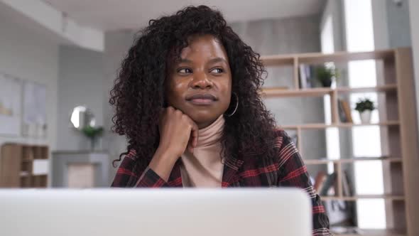 Cute Black Business Woman Working Online at Home Using a Video Call Application on a Computer