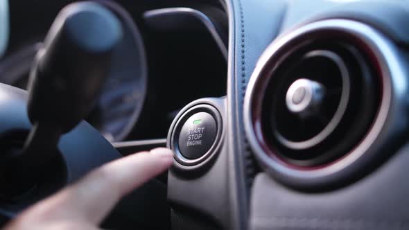 Woman's Finger Starting Car Engine Pressing Button