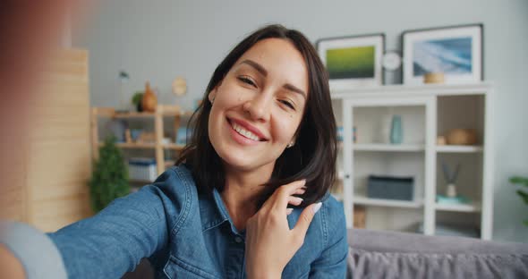 Point of View of Girl Taking Selfie Smiling Posing Looking at Camera at Home