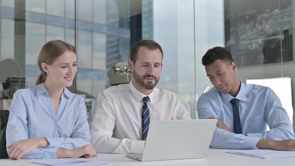 Business People Doing Video Chat on Laptop on Office Table