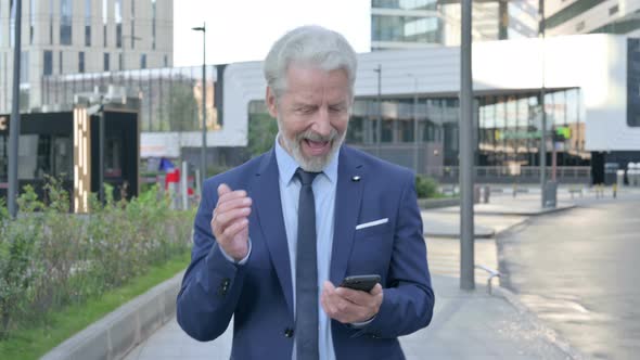 Walking Old Businessman Celebrating Success on Phone