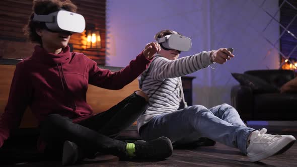 Teenage Gamers Playing Video Game in VR Headsets