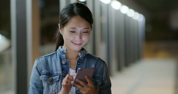 Woman Look at Mobile Phone at Night