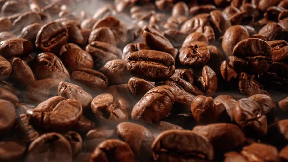 Close Up of Seeds of Coffee. Fragrant Coffee Beans Are Roasted Smoke Comes From Coffee Beans