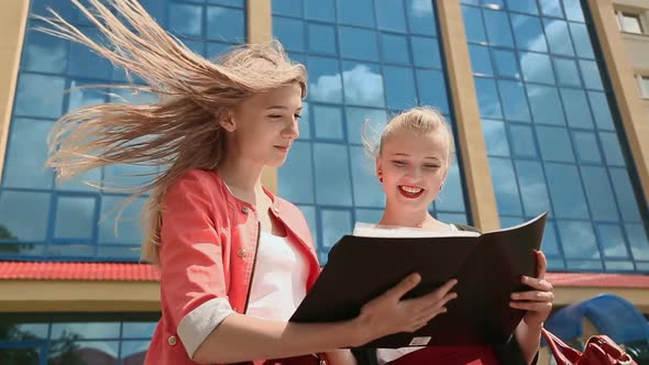 Two Young Business Girls Working with Papers