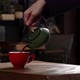 Cinematic Slow Motion Pouring Herbal Tea in Red Cup from Green Tea Pot - VideoHive Item for Sale