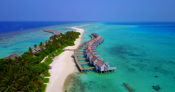 Natural overhead tourism shot of a summer white paradise sand beach and blue sea background in 4K