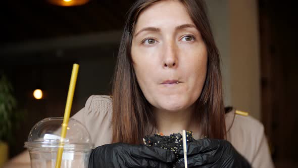 Woman Eating Fast Food Chicken Burger at Restaurant