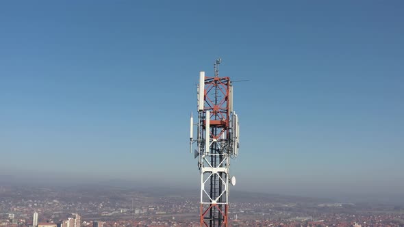Telecommunication tower above high populated area 4K drone footage