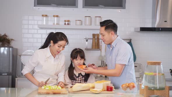 Family relationship, Asian happy family making foods preparation with kid in kitchen room at home.