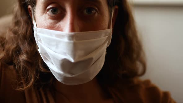Caucasian woman wearing a face mask at home