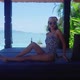 Pretty Asian Girl In Swimming Suit Sitting Smiling Alone in Resort on Sunny Day - VideoHive Item for Sale