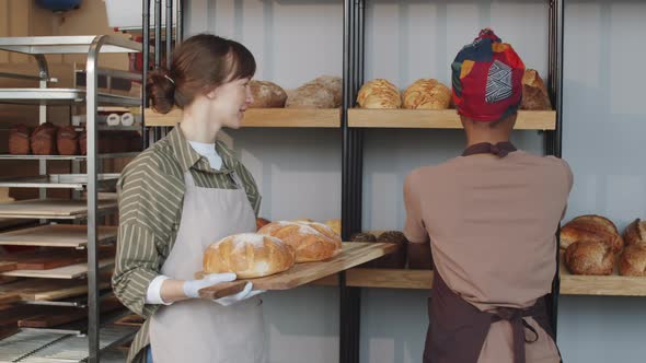 Multiethnic Women Smiling and Chatting during Workday in Bakery