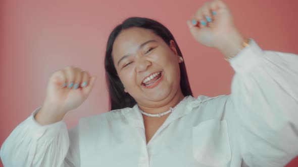 Asian Plus Size Woman in White Shirt Posing Isolated on Pink Background