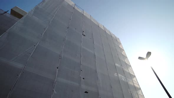 Building Scaffolding Covered with White Protective Fabric