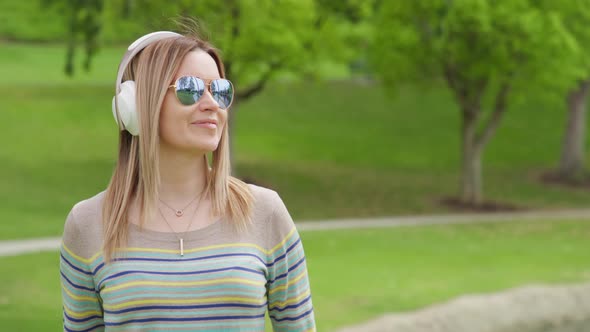 Portrait of Young Caucasian Blonde Woman with Headphones Listening to Music RED
