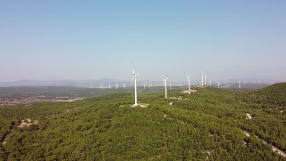 Aerial View Over the Farm Landscape and Wind Turbines Generating Clean Renewable Energy