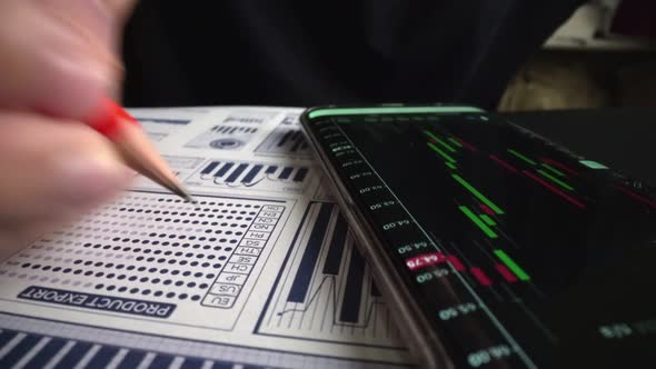 Accountant Analyzing Business Marketing Data on Paper Dashboard at Office Table