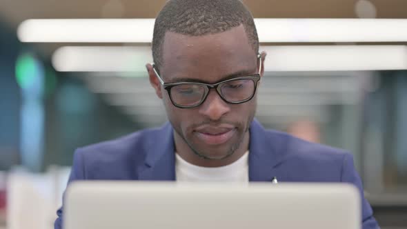 Young African Businessman Working on Laptop in Office