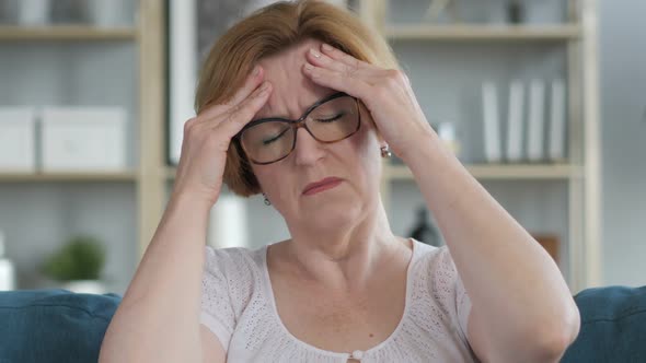 Headache Portrait of Tense Old Senior Woman in Office