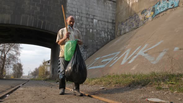 Unemployed Male Collecting Blastic Bottles