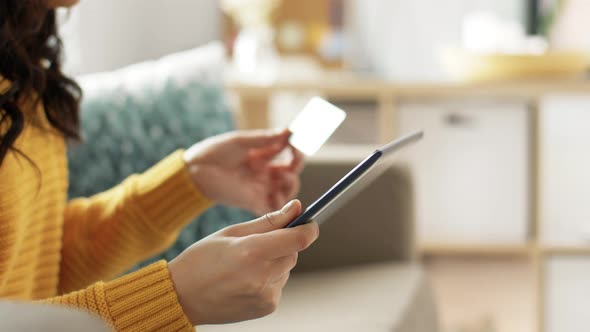 Asian Woman with Tablet Pc and Credit Card at Home