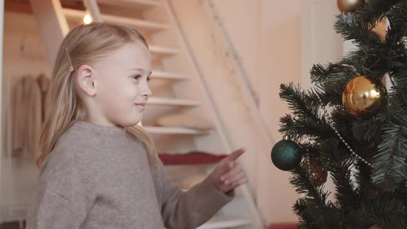 Girl Touching Christmas Toy