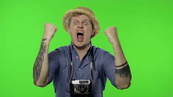 Portrait of Young Man Tourist Photographer Looking Displeased, Angry. Chroma Key