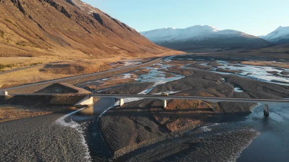 Aerial View of Car Crossing the Bridge Over Glacial River in Icelandic Highlands Drone Shot
