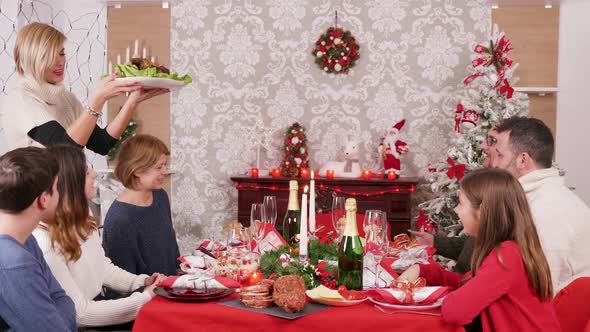 Big Family Gathered Around Christmas Table Enjoying Traditional Food