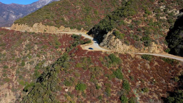 Flying over a blue Tesla Model S on Mt. Baldy in Southern California.