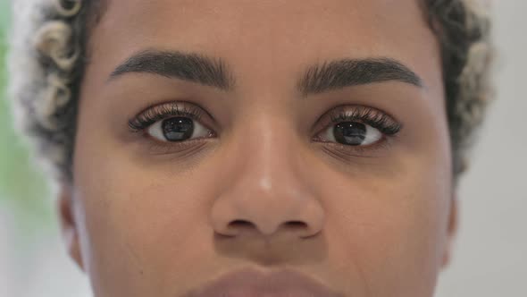 Close Up of Blinking Eyes of African Woman Looking at the Camera