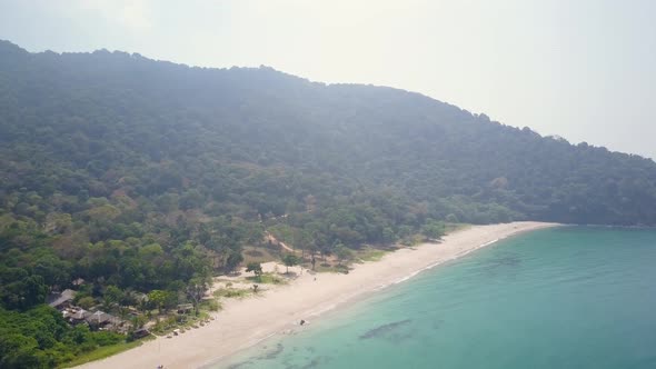 Aerial view of beach and natural forest in Thailand - lateral tracking panning shot