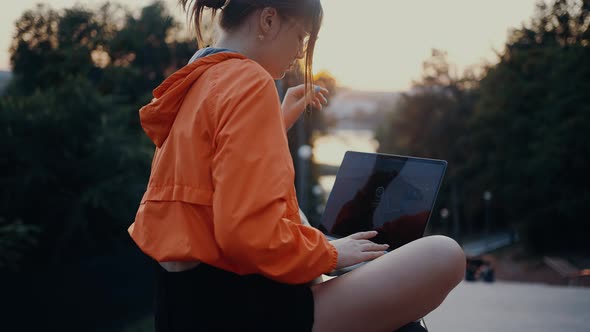 A Beautiful Relaxed Young Woman Sits in Her Laptop and Wants to Type Something