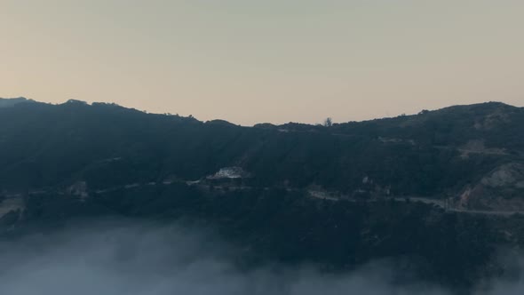 Mountains with forest and road in fog from a bird's eye in Malibu Canyon, Calabasas, California, USA