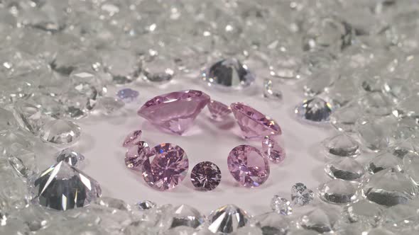 Top view pink diamonds placed on a pile of white diamonds