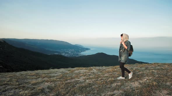 Woman Hiker Walking on Mountain Terrain Wearing Backpack