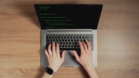 Closeup a Man's Hands are Typing Commands of a Laptop Keyboard