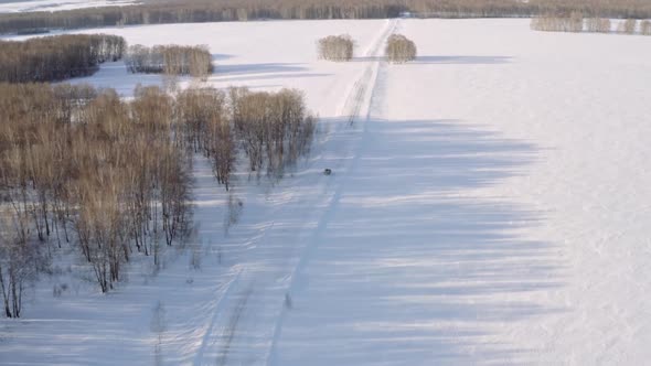 Winter road with traveling car