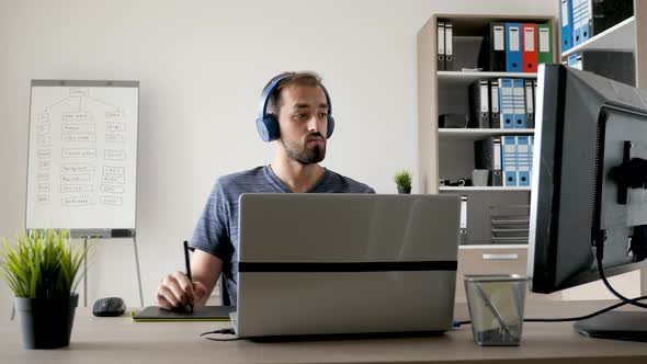 Artist at His Desk Working with a Digital Tablet