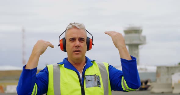 Male engineer gesturing in airport 