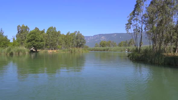 A River Surrounded By Reeds On A Flat Plain