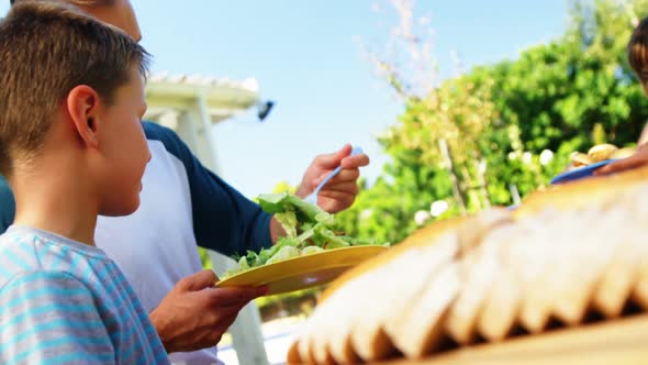 Family having meal in house garden