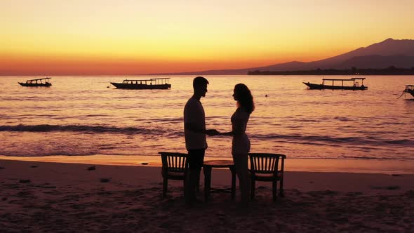 Guy and girl posing on marine coastline beach holiday by transparent ocean with white sand backgroun