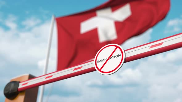 Opening Barrier with Stop Immigration Sign at the Swiss Flag alt