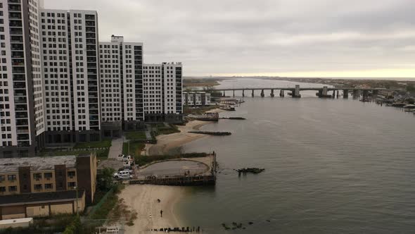 An aerial shot over the East Rockaway Inlet in NY. The drone dolly in to the Nassau Expressway, past